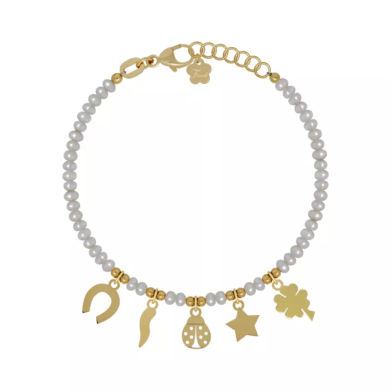 An 18kt gold baby pearl bracelet with lucky charms featuring a horseshoe, cornicello, ladybug, star, and clover.