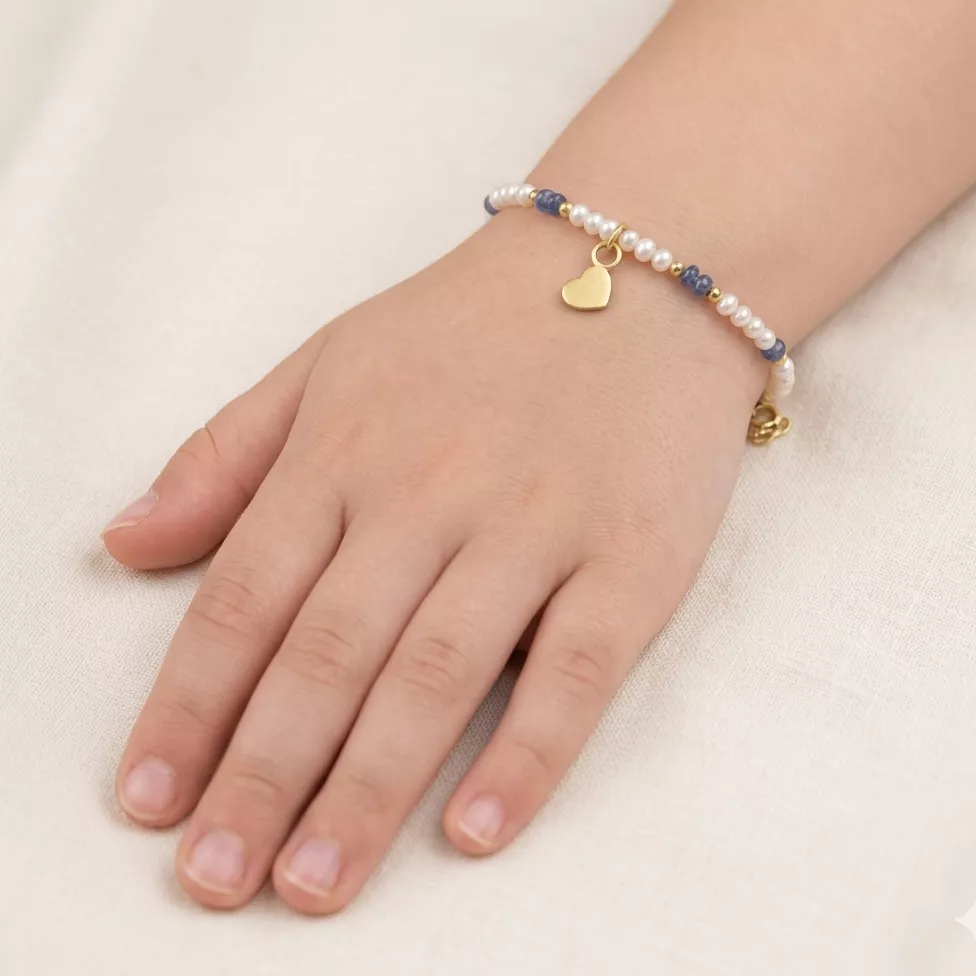 An 18kt gold baby bracelet with pearls, sapphire beads, and a dangling heart charm.