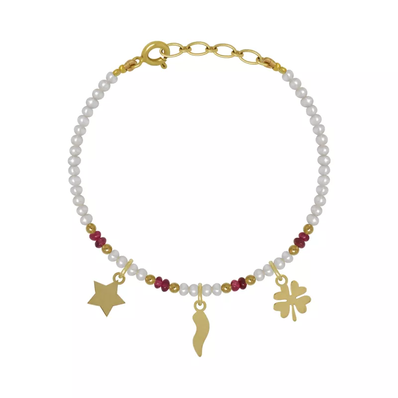 An 18kt gold baby bracelet with pearls, spinel beads, and three dangling charms including a clover leaf, cornicello and star.