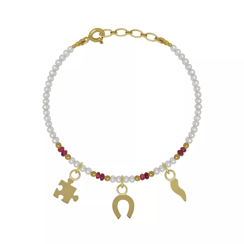 An 18kt gold baby bracelet with pearls, spinel beads, and three dangling charms including a cornicello, horse shoe, and puzzle piece.